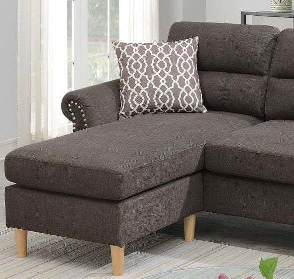 Dark grey fabric chaise lounge with decorative nailhead trim on the armrest
