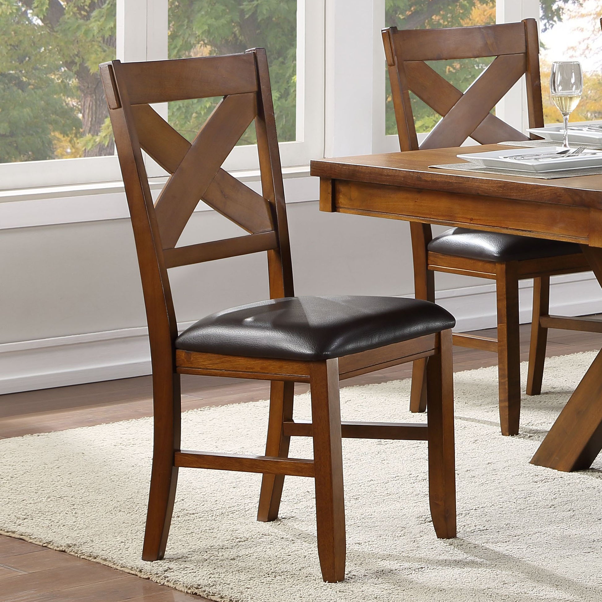 Rich brown wooden dining chair with dark faux leather seat and crisscross back