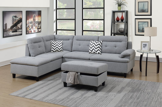 Light grey sectional sofa with tufted back and chaise featuring chevron pillows and storage ottoman