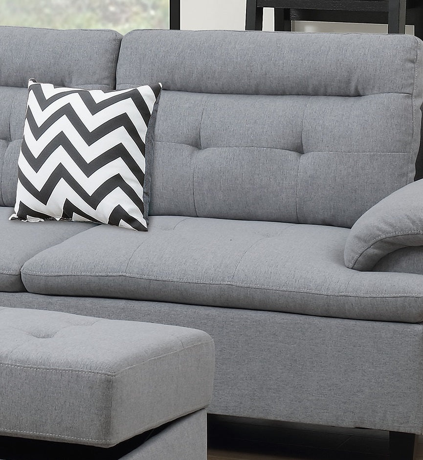Grey fabric sectional sofa with chevron throw pillow and tufted ottoman