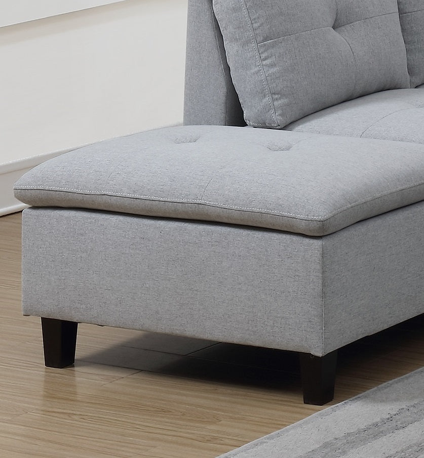 Light gray upholstered sofa chaise with tufted cushion and dark wooden legs