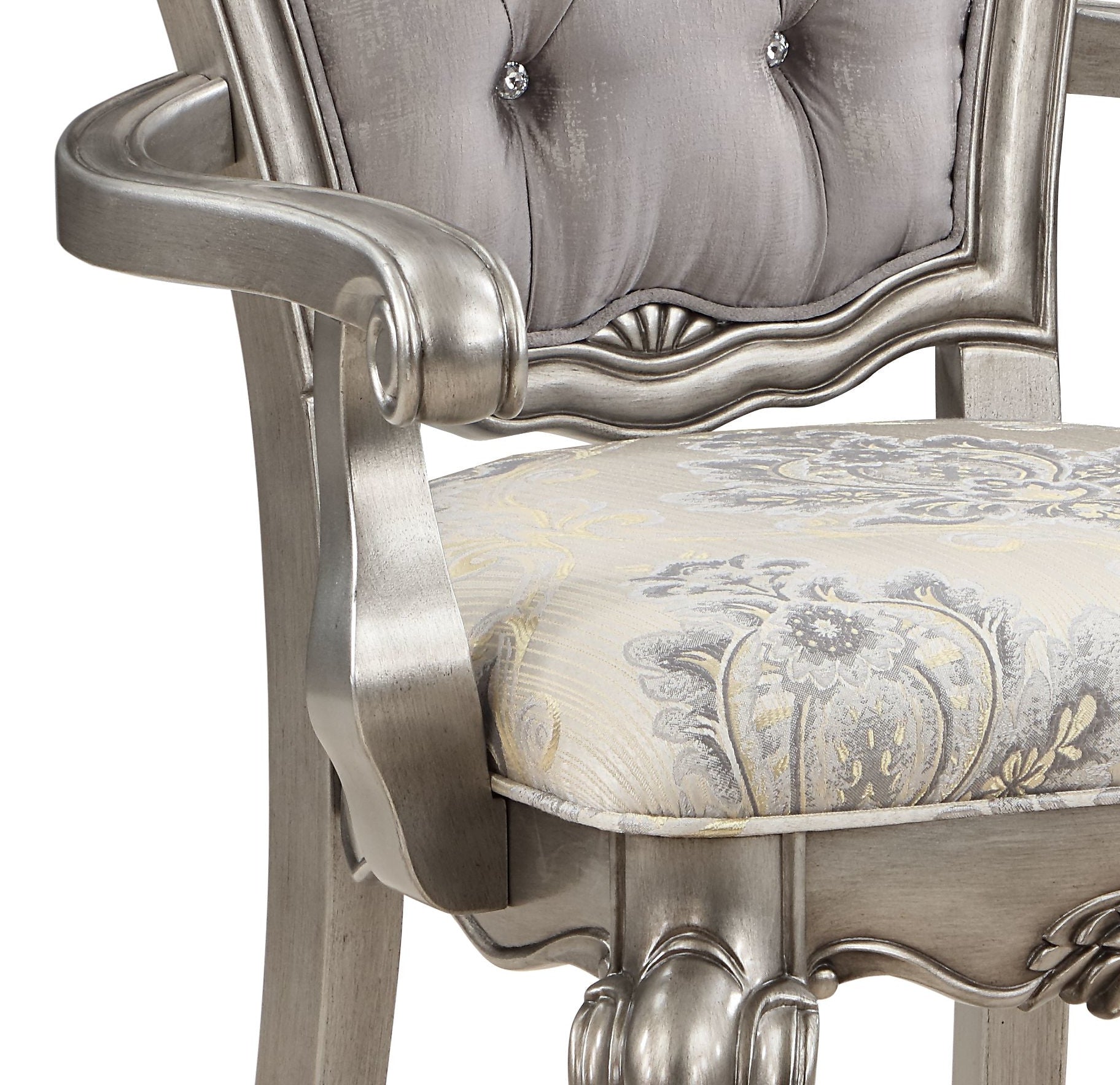 Ornate silver tufted armchair with detailed damask seat cushion