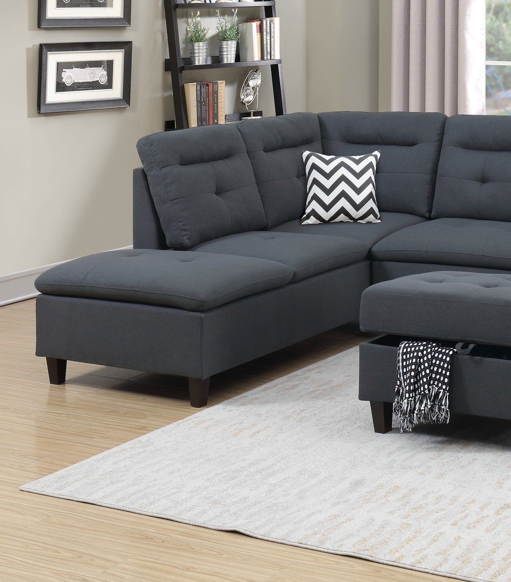 Dark gray tufted sectional sofa with chaise and storage ottoman