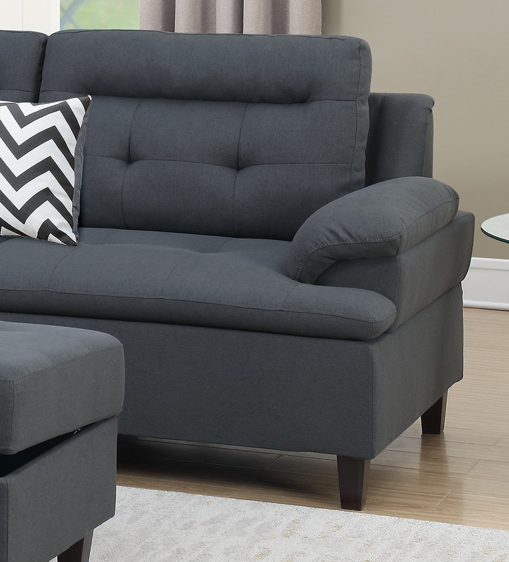 Deep charcoal sectional sofa with tufted back cushions and rolled arms