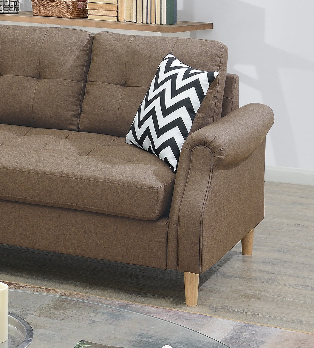 Tufted brown fabric sofa with a black and white chevron throw pillow