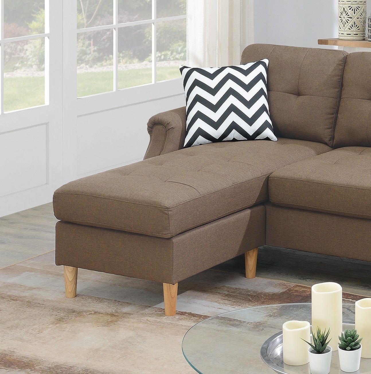 Brown fabric sectional sofa with tufted chaise lounge and black and white chevron pillow