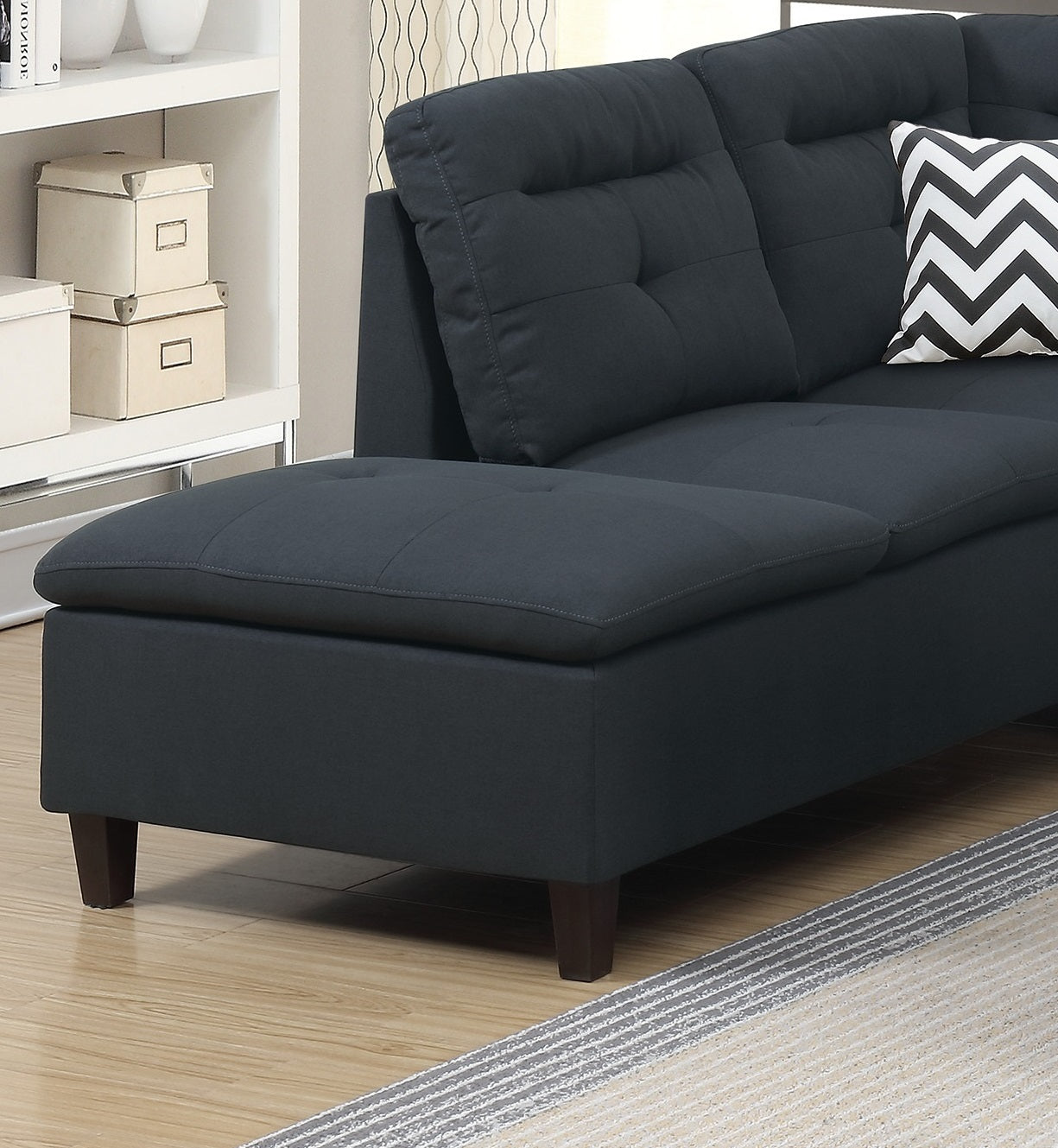 Dark charcoal grey sectional sofa chaise with tufted cushions and espresso wood legs