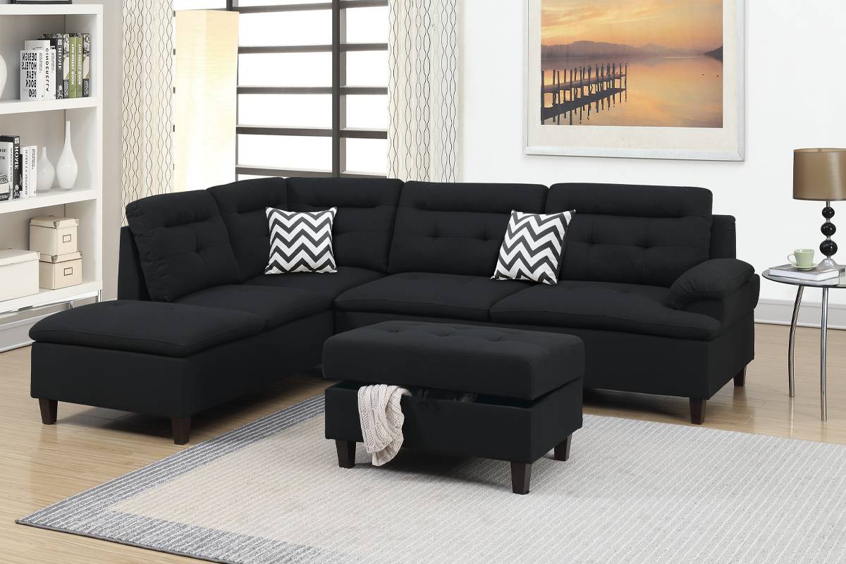Black fabric sectional sofa with tufted cushions and chevron pattern accent pillows