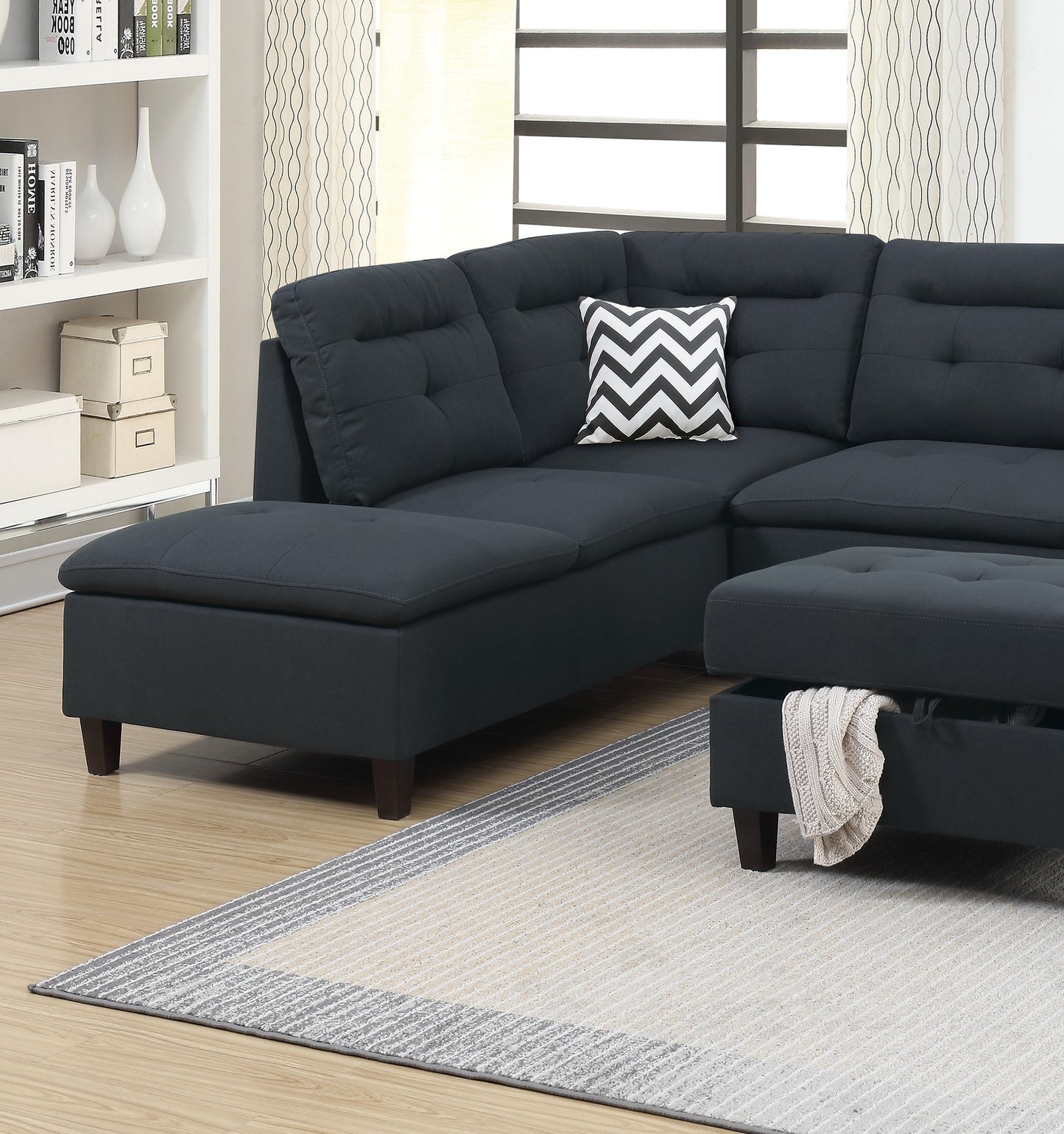 Dark gray tufted sectional sofa with chaise and ottoman