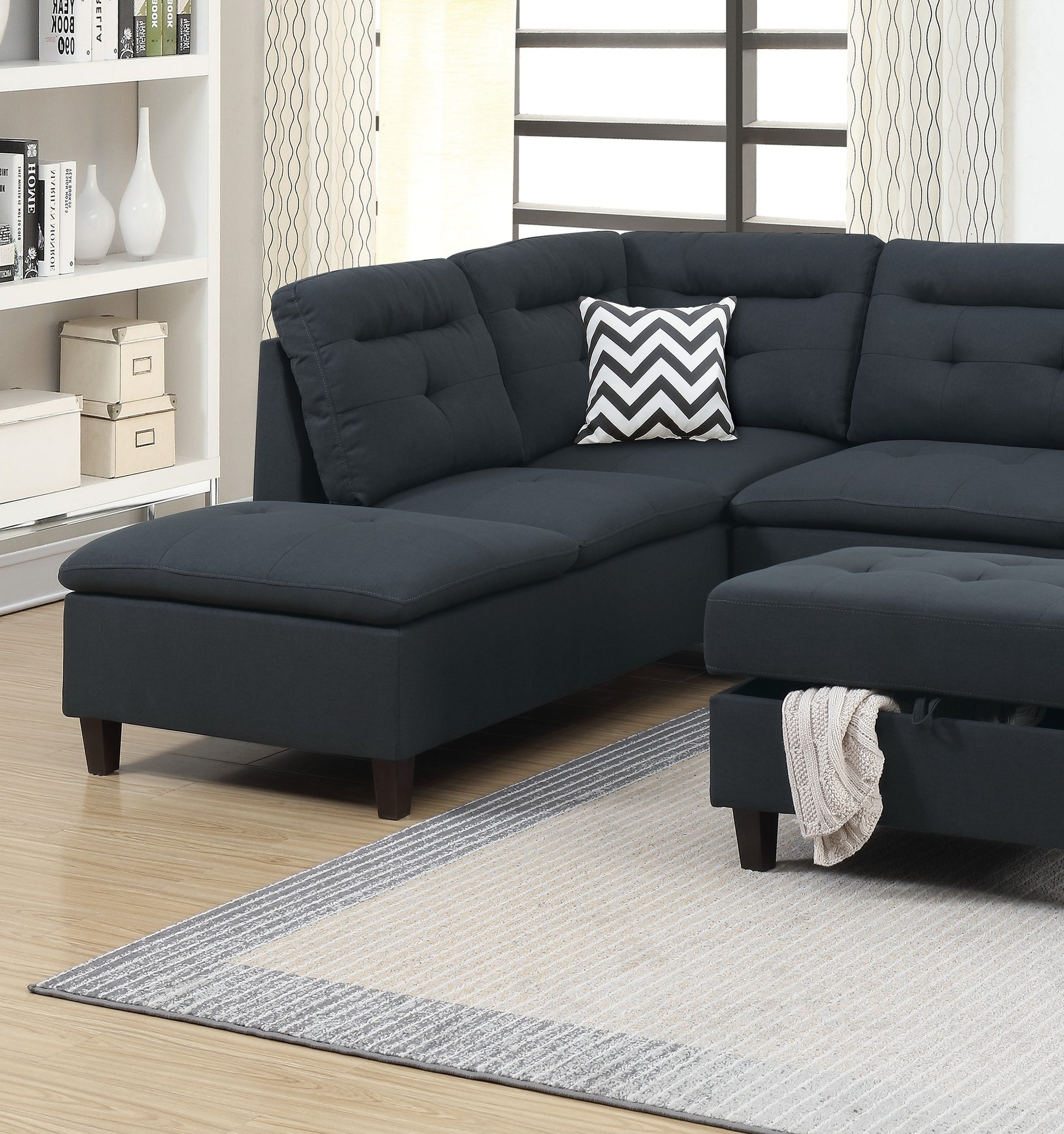 Dark gray tufted sectional sofa with chaise and ottoman