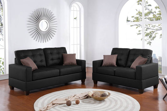 Tufted black faux leather loveseat with brown accent pillows and wooden legs