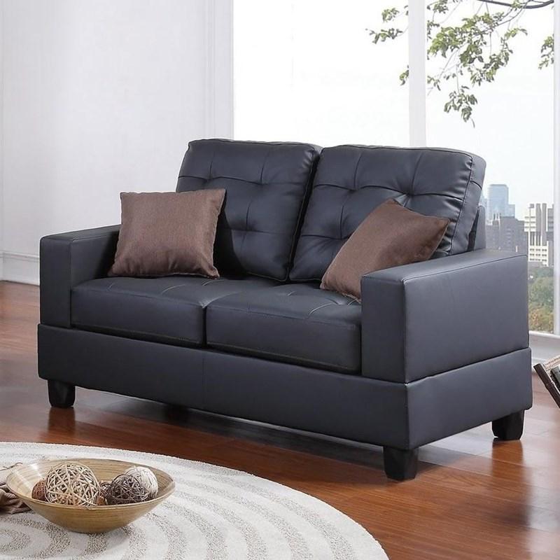 Tufted black leather loveseat with two brown throw pillows perfect for small spaces
