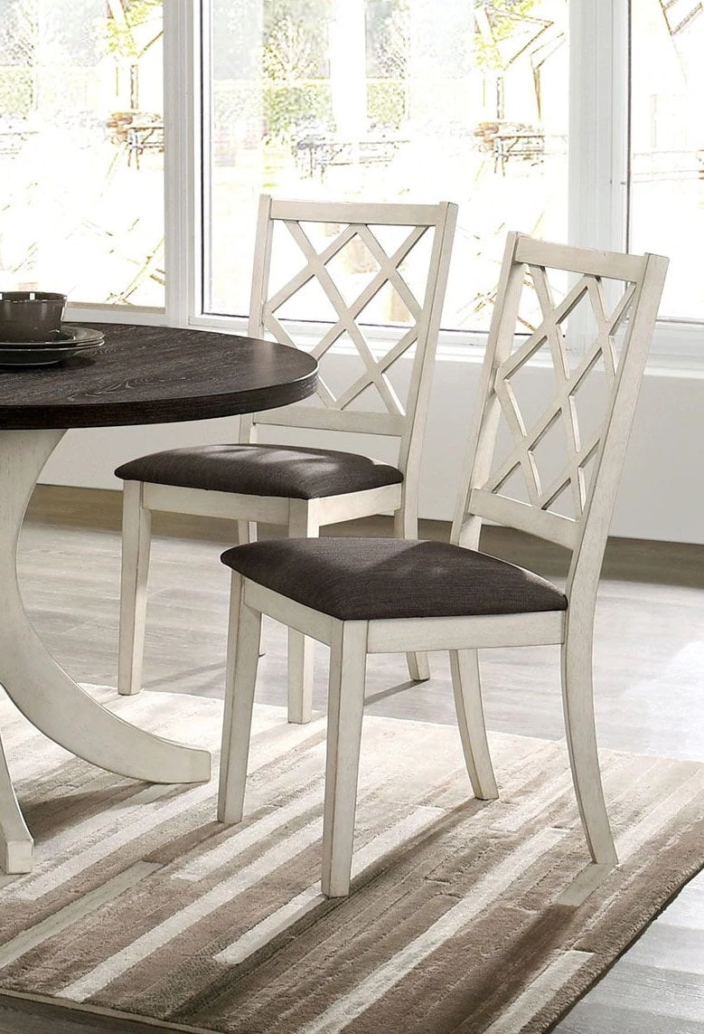 Distressed white lattice back dining chair with dark upholstered seat perfect for a farmhouse kitchen