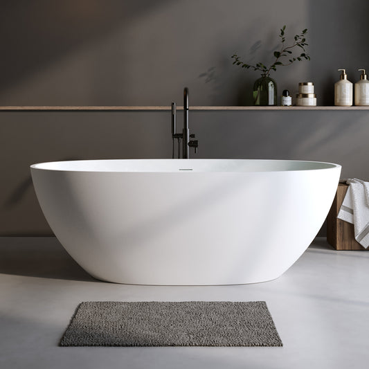 Modern white oval freestanding bathtub with matte black faucet and grey bath mat