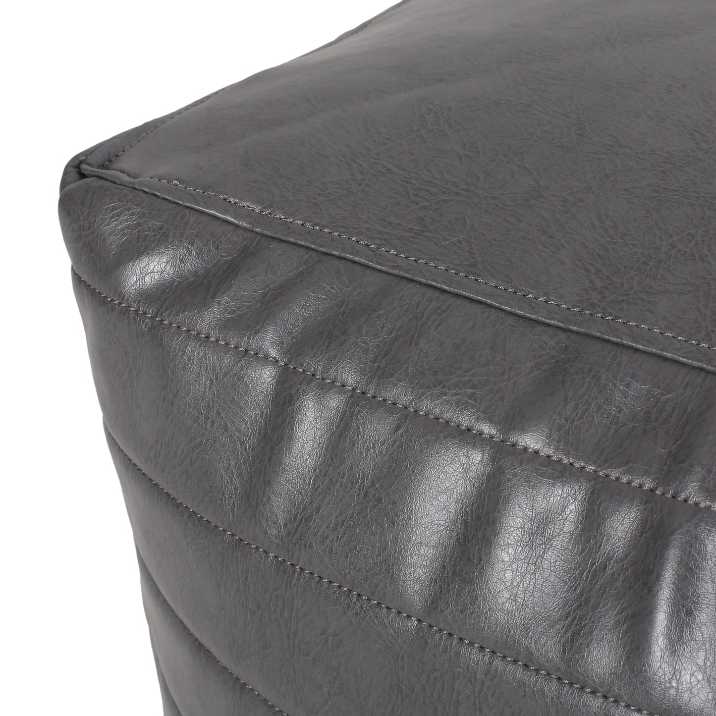 Quilted charcoal faux leather ottoman corner with subtle stitching detail