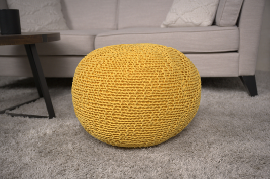 Round yellow knitted ottoman a versatile footrest for modern living rooms