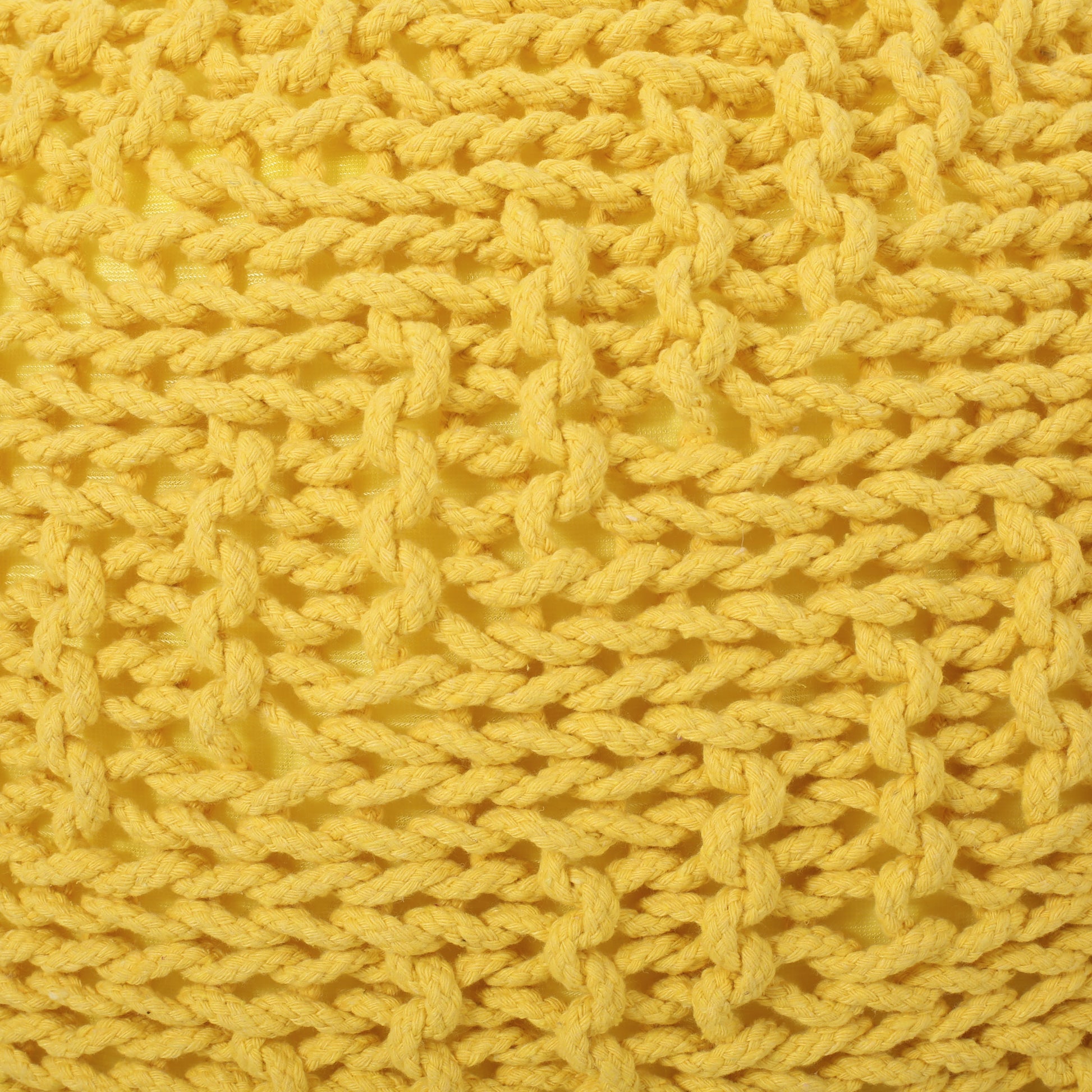 Closeup of textured yellow knit fabric with thick braided yarn details
