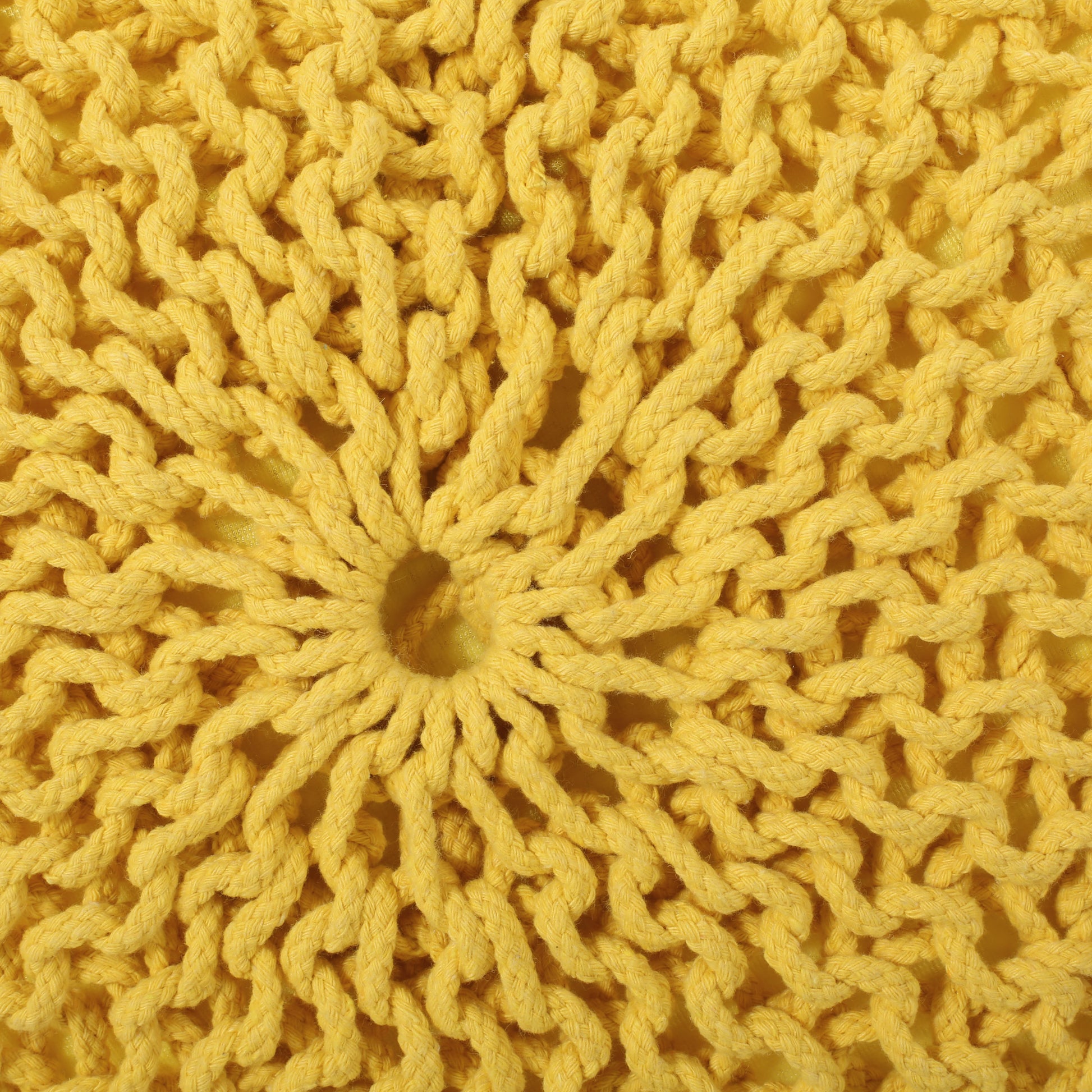 Yellow chunky knit pouf cushion with braided rope texture