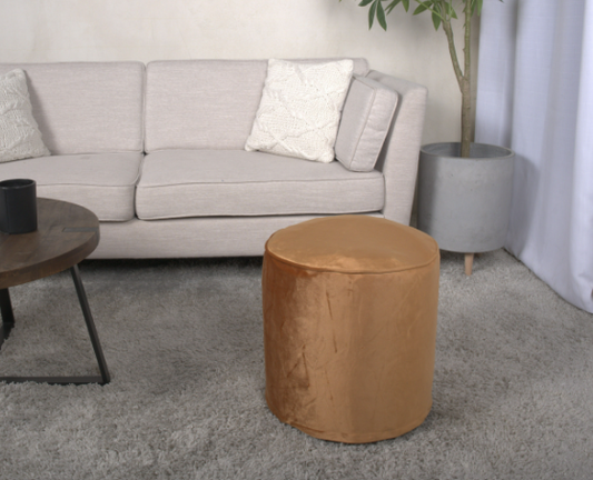 Plush velvet ottoman in a warm caramel hue perfect for modern living rooms