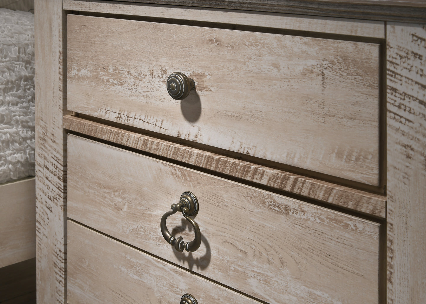Distressed oak dresser with antique brass drawer pulls perfect for rustic bedroom decor