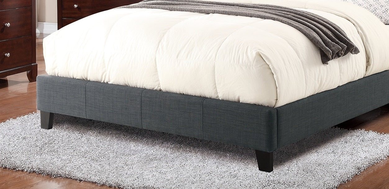 Dark gray upholstered platform bed frame with white comforter and textured throw