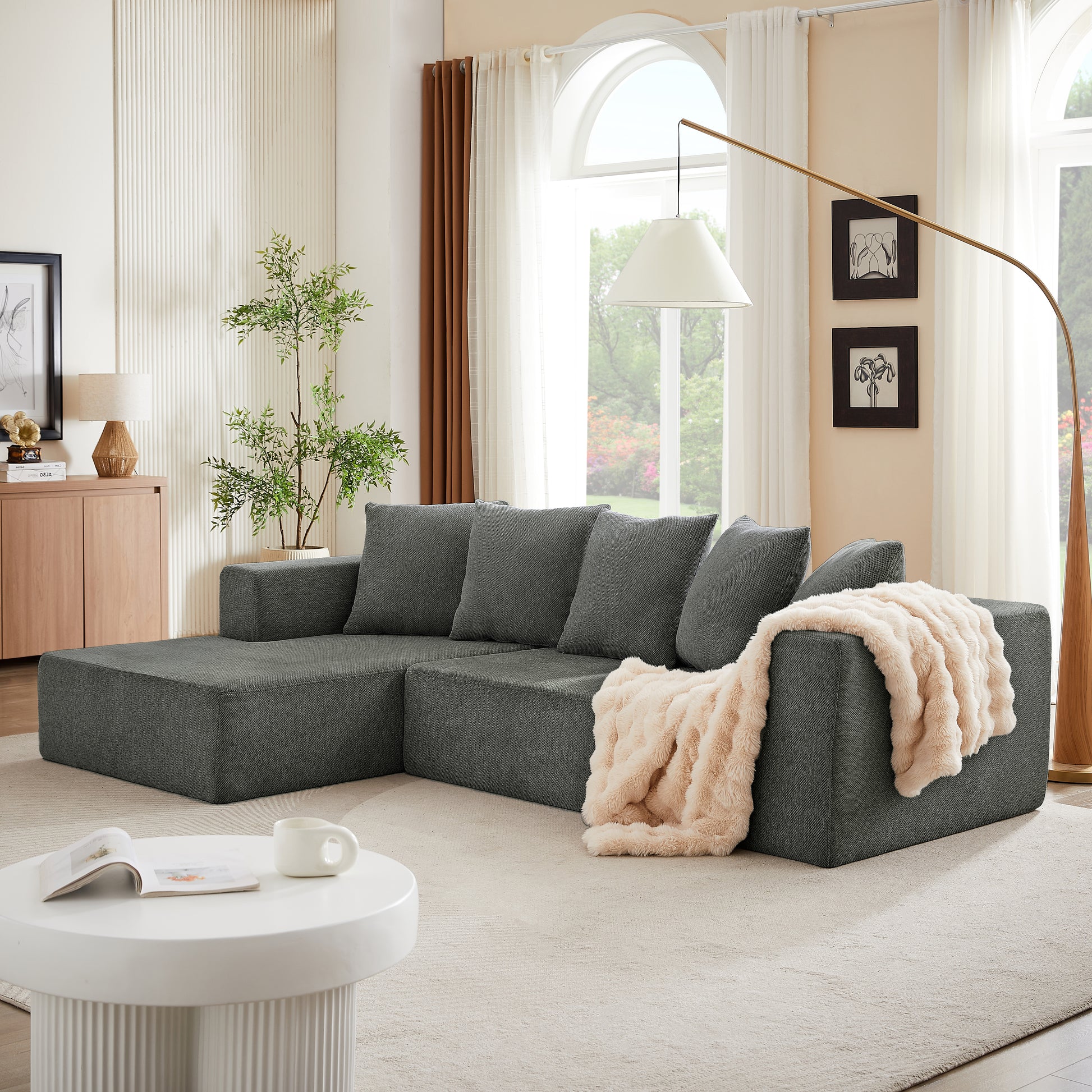 Modern grey sectional sofa with plush throw perfect for contemporary living rooms