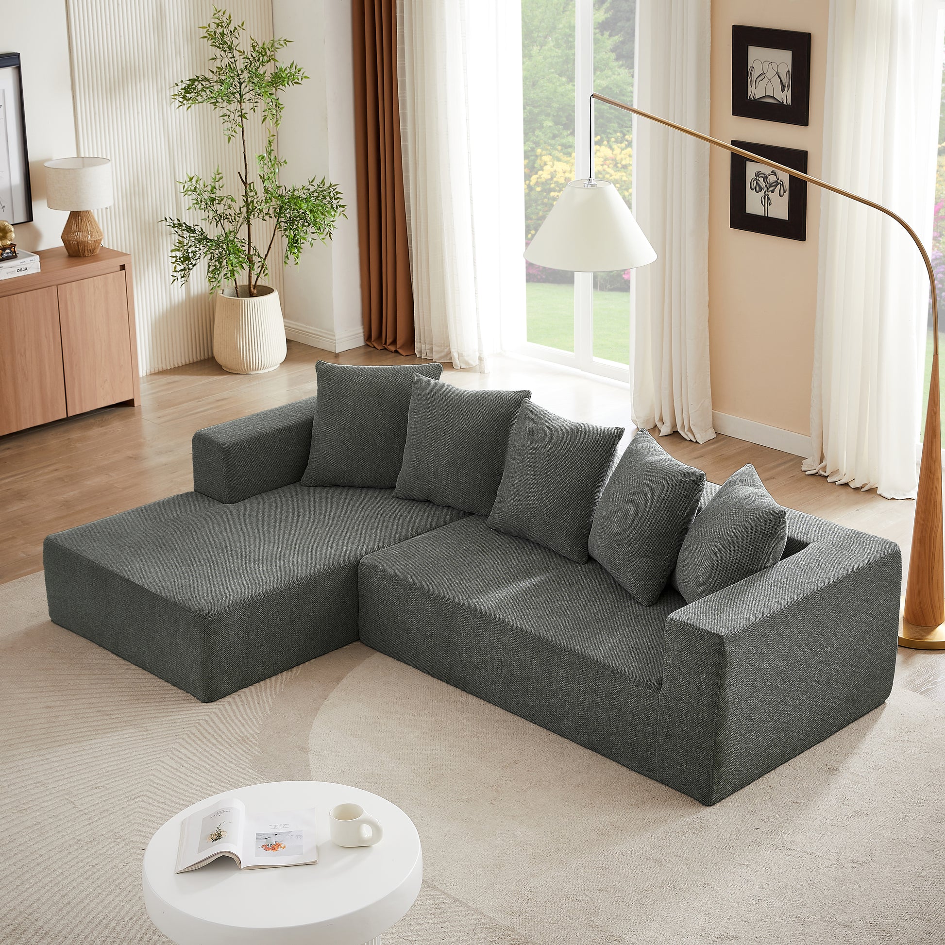 Modern dark grey fabric sectional sofa with plush throw pillows perfect for living room comfort