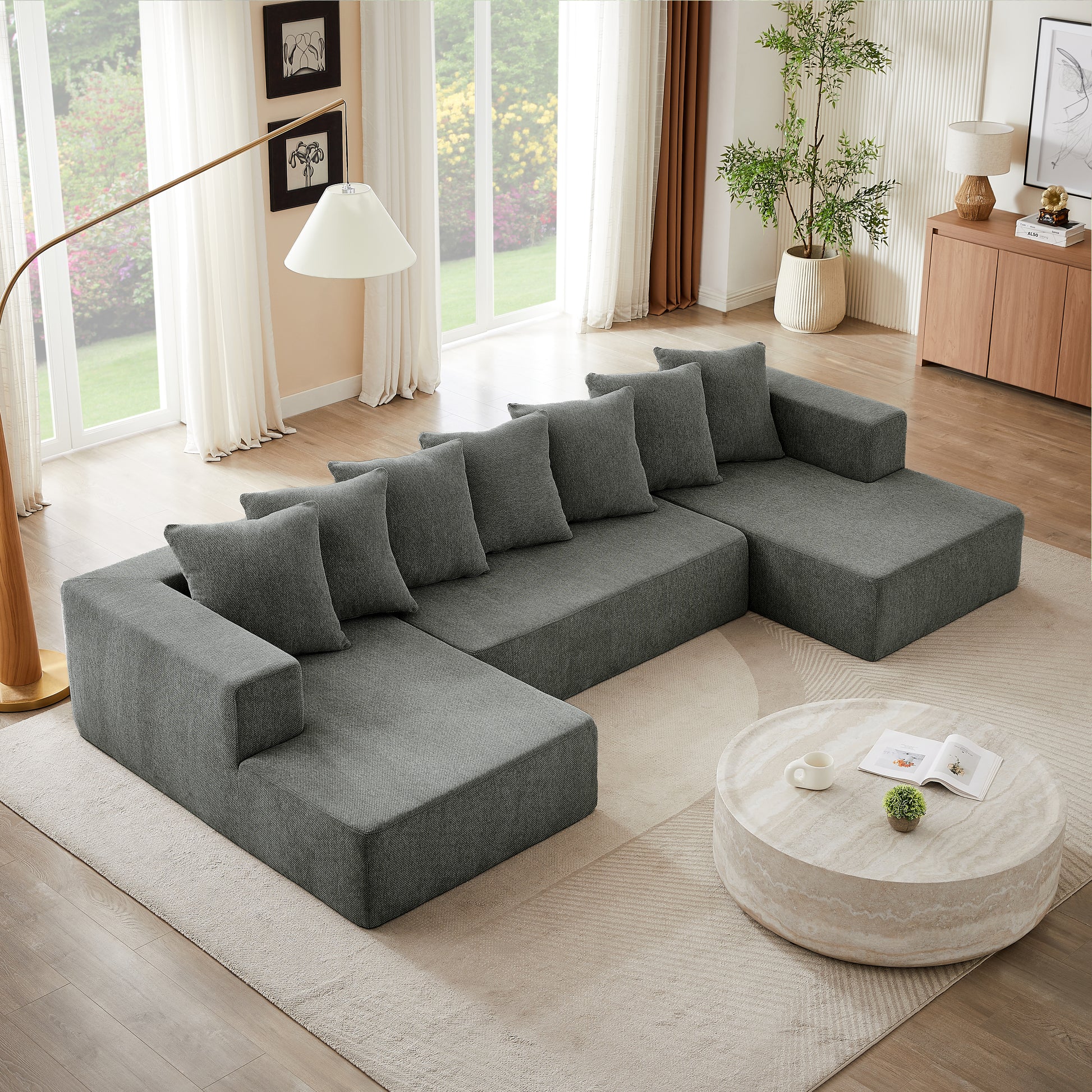 Spacious Ushaped sectional sofa in charcoal grey fabric with plush cushions for modern living rooms