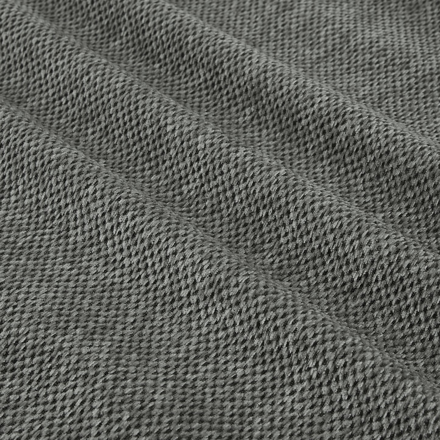 Closeup texture of a grey knitted fabric with visible loops and a soft plush feel ideal for cozy apparel