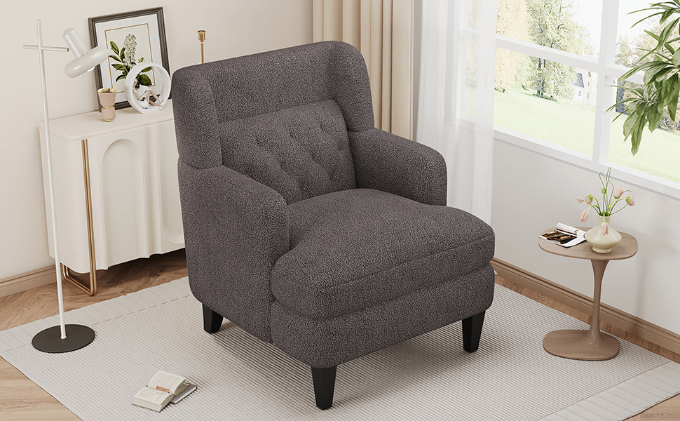Dark grey textured accent chair with tufted backrest and wooden legs