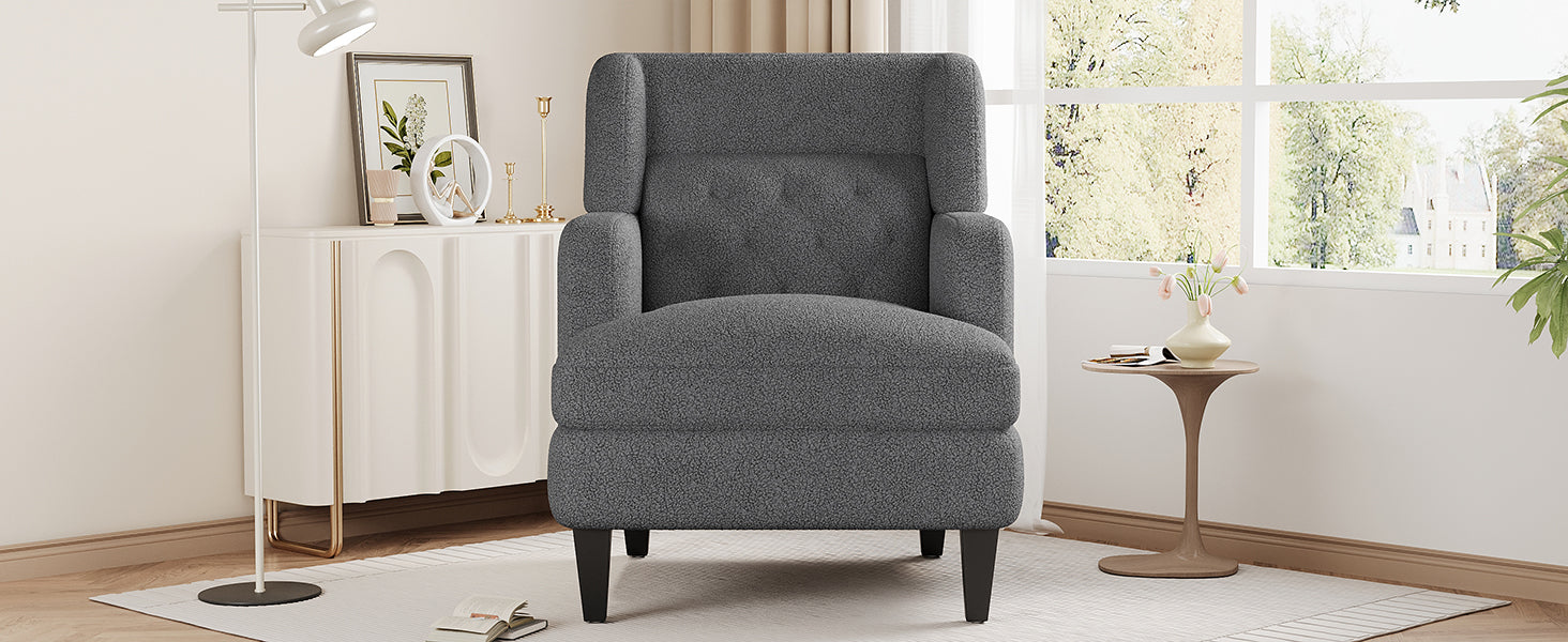 Dark gray boucle accent chair with button tufting and black tapered legs