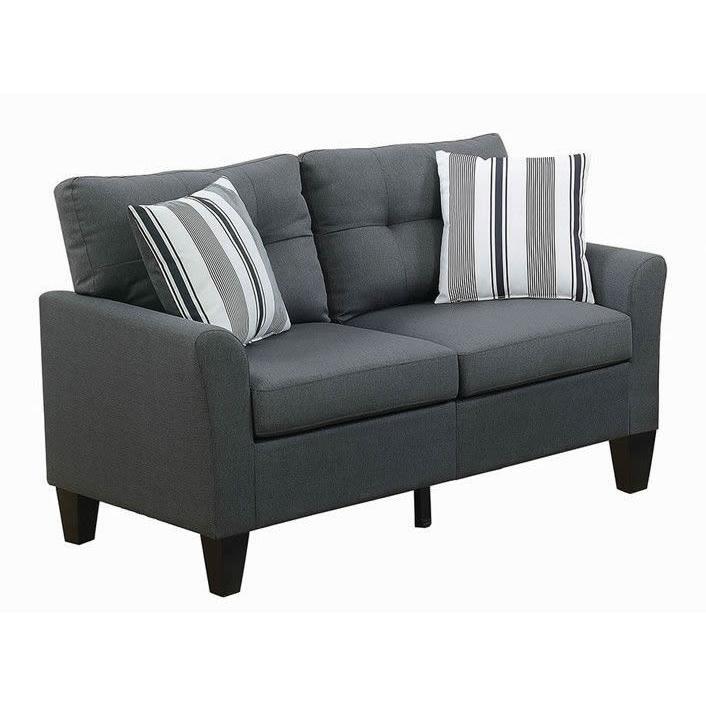 Dark grey upholstered loveseat with striped accent pillows