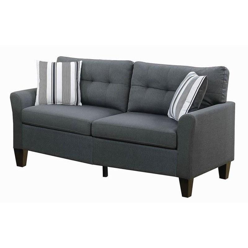 Modern dark grey fabric sofa with tufted back cushions and striped accent pillows
