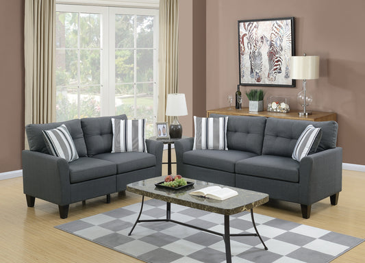Dark grey fabric sofa set with tufted cushions and striped accent pillows