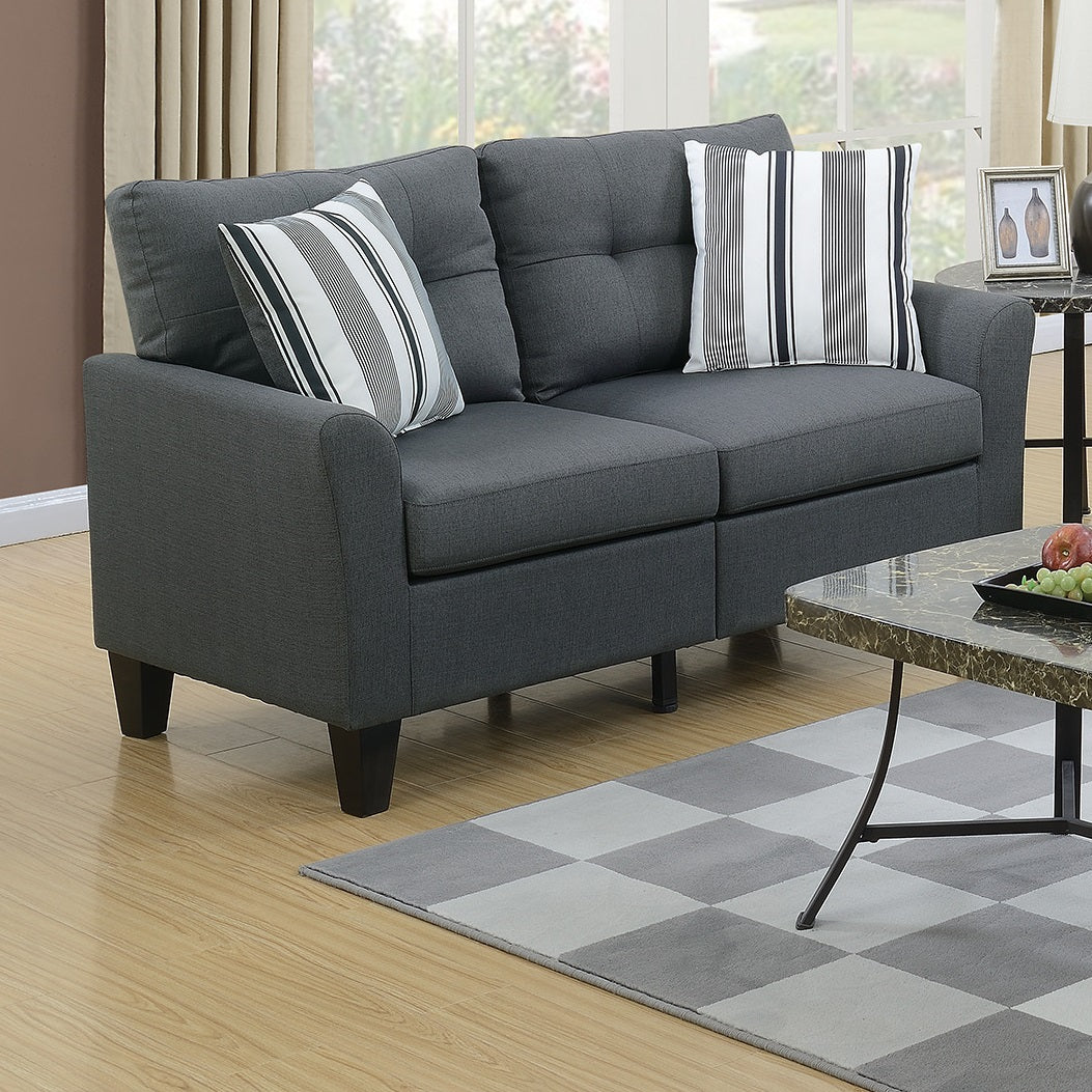 Dark gray fabric loveseat with tufted back and striped accent pillows