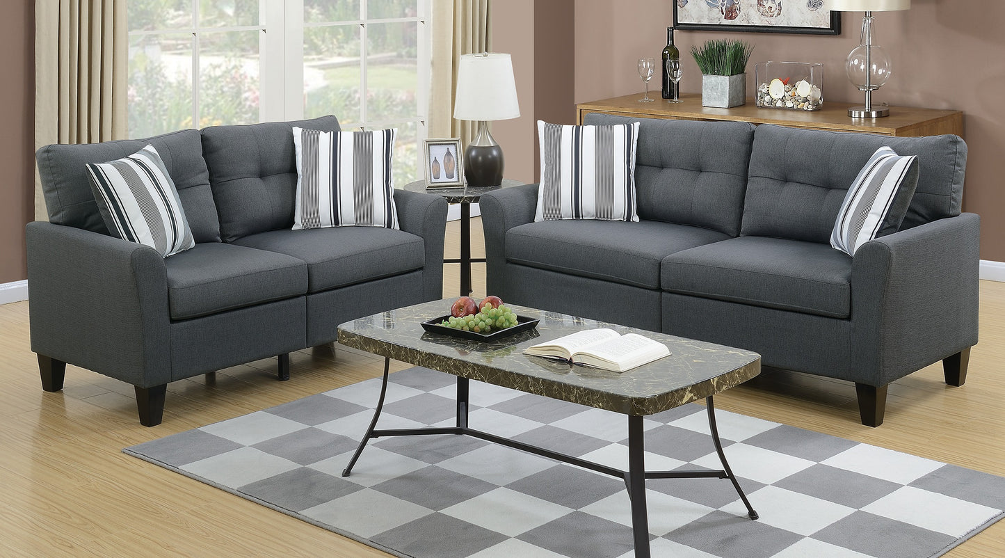 Dark gray upholstered sofa set with tufted cushions and striped accent pillows