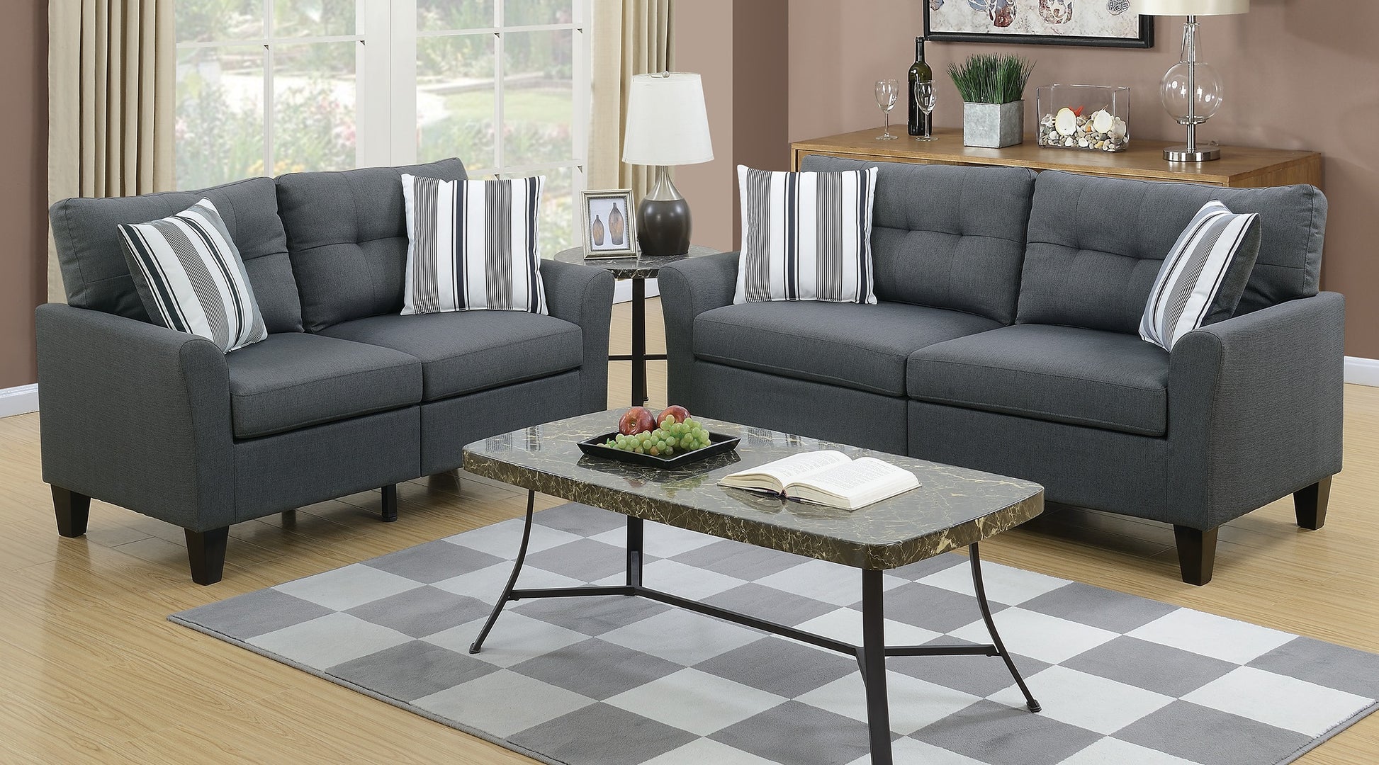 Dark gray upholstered sofa set with tufted cushions and striped accent pillows