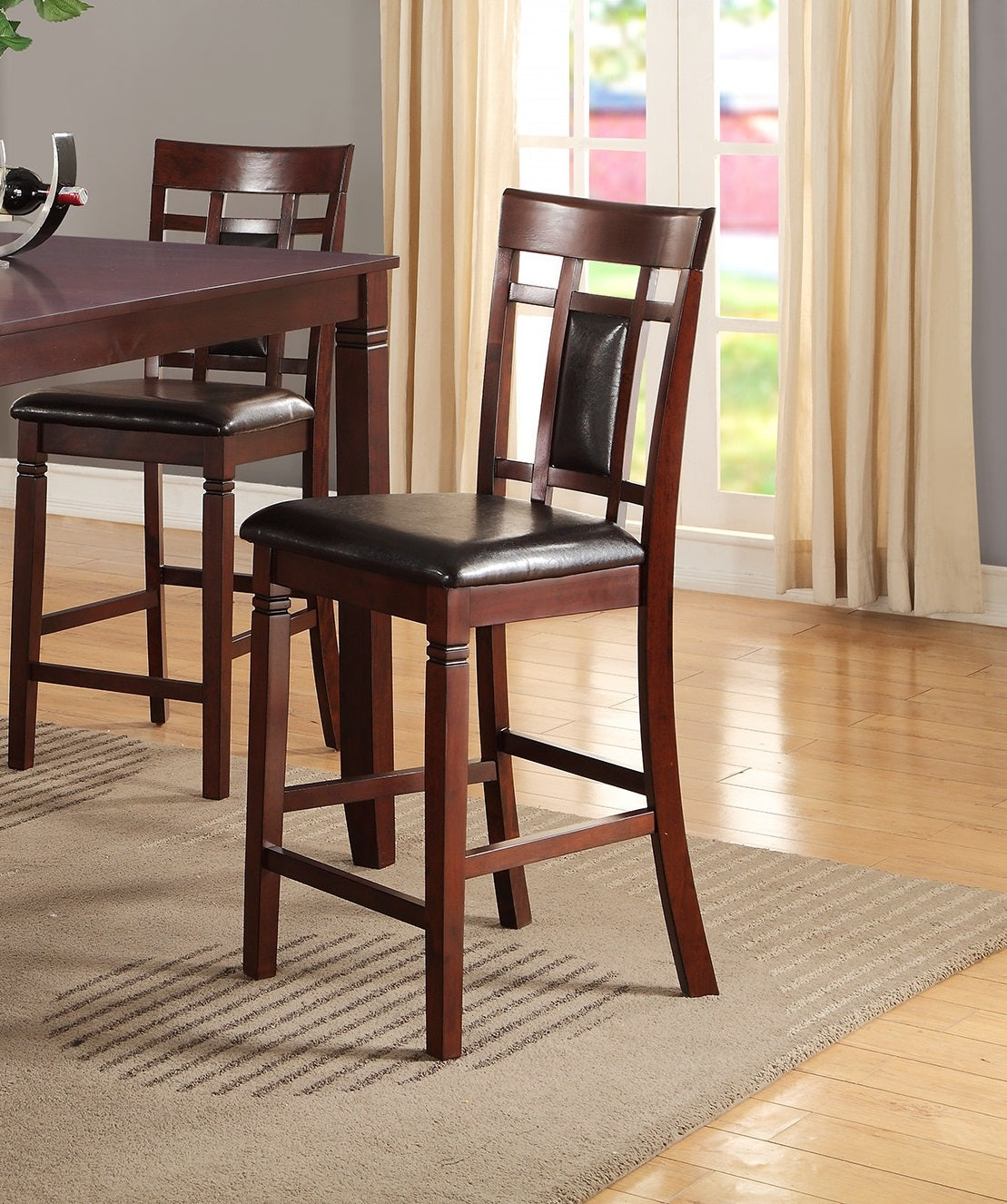 Rich brown wooden bar stool with dark leather seat and slatted back