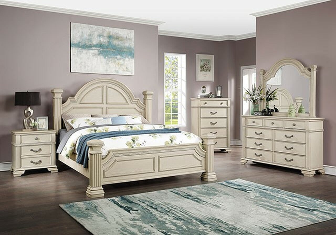 Cream carved wood bed frame with floral bedding a matching nightstand and dresser