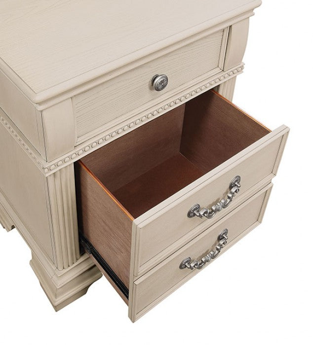 Beige wooden nightstand with ornate silver drawer pulls and an open drawer revealing its interior