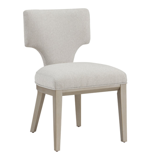 Light beige upholstered dining chair with carved wood legs and a curved backrest