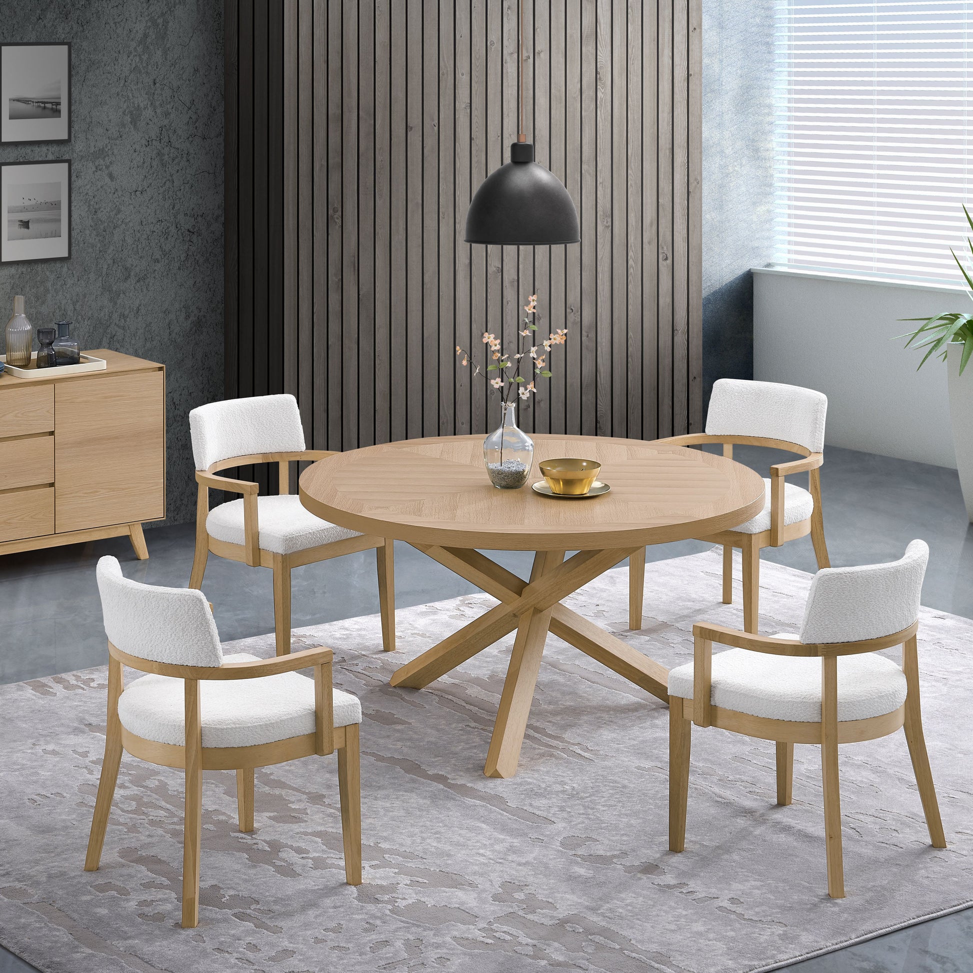 Round oak dining table with four white boucl armchairs perfect for modern dining rooms