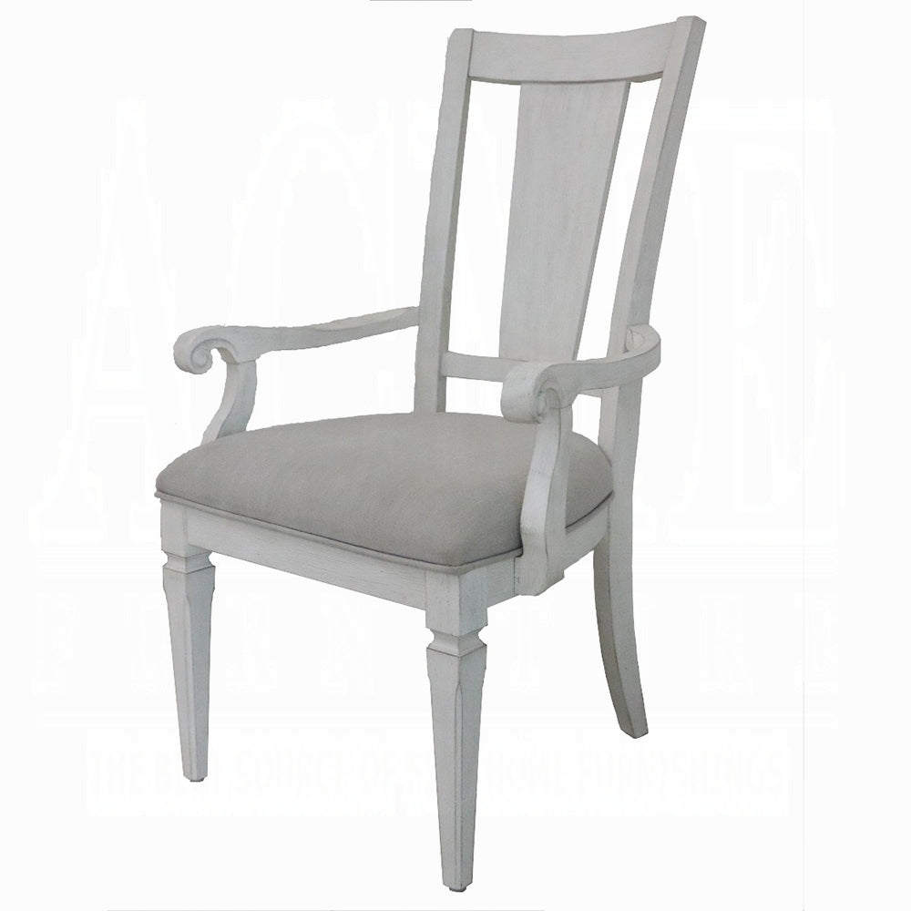 Whitewashed wood dining chair with upholstered gray seat and scrolled arms