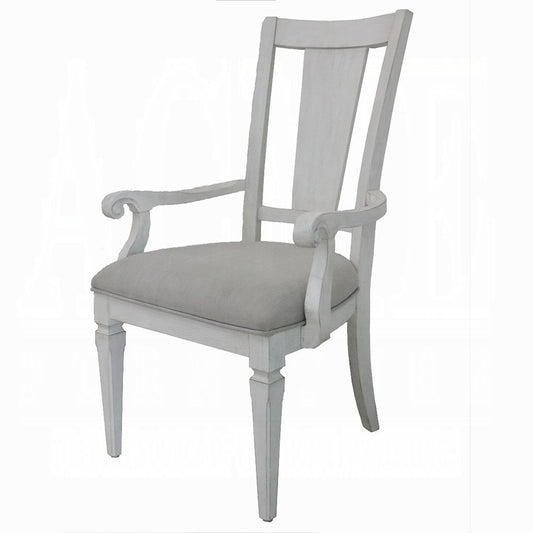 Whitewashed wood dining chair with upholstered gray seat and scrolled arms