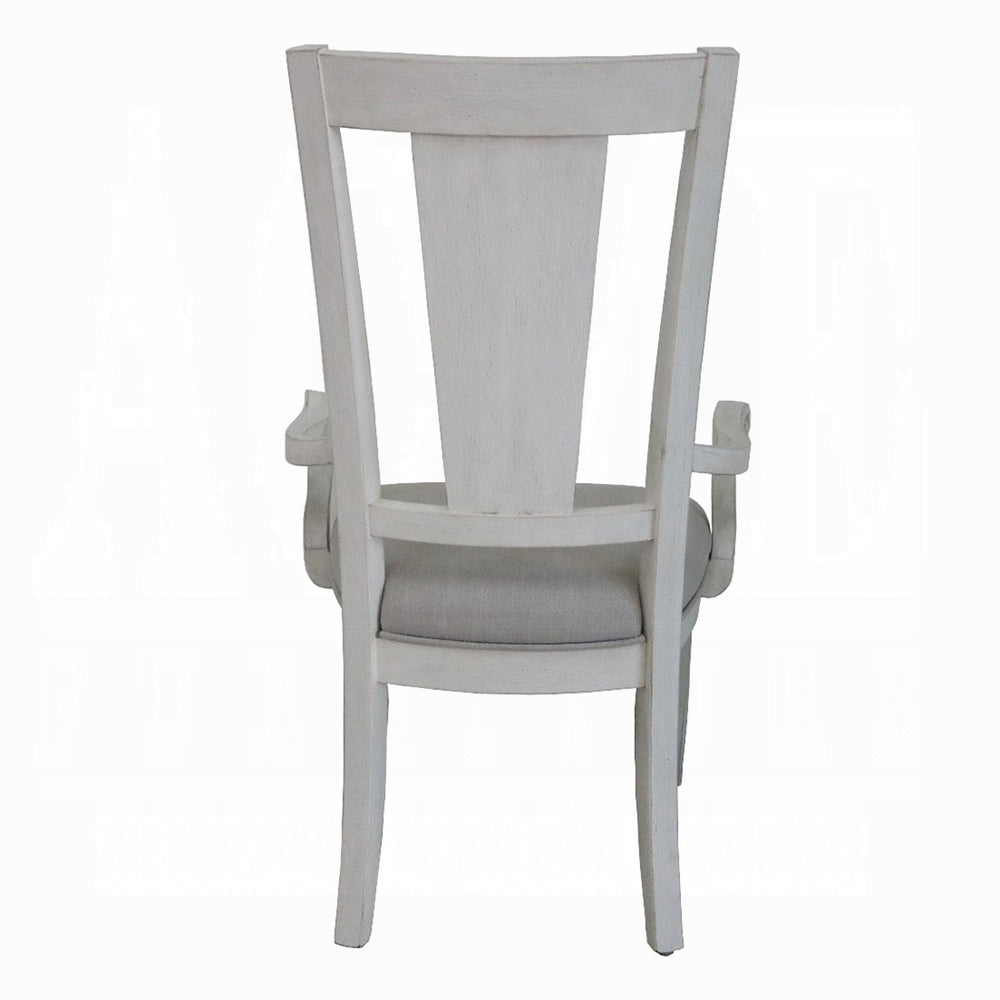 Back view of a distressed white wooden armchair with a gray upholstered seat