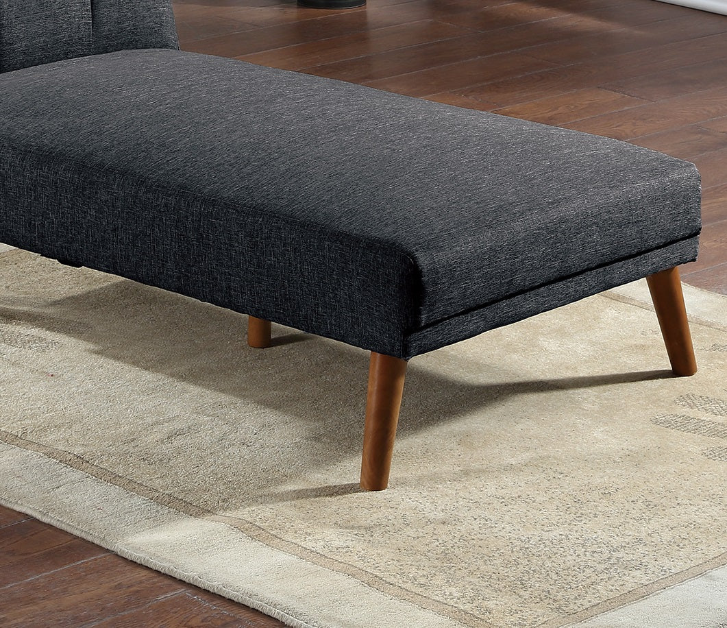 Dark gray upholstered chaise lounge with tapered wooden legs on a cream rug