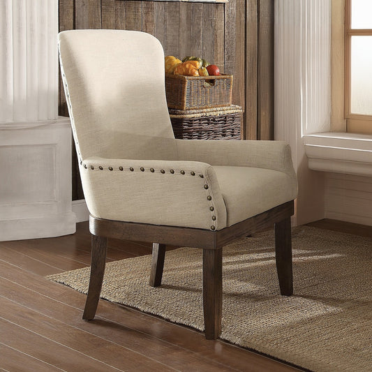 Upholstered arm chair with nailhead trim and natural linen fabric complementing farmhouse decor