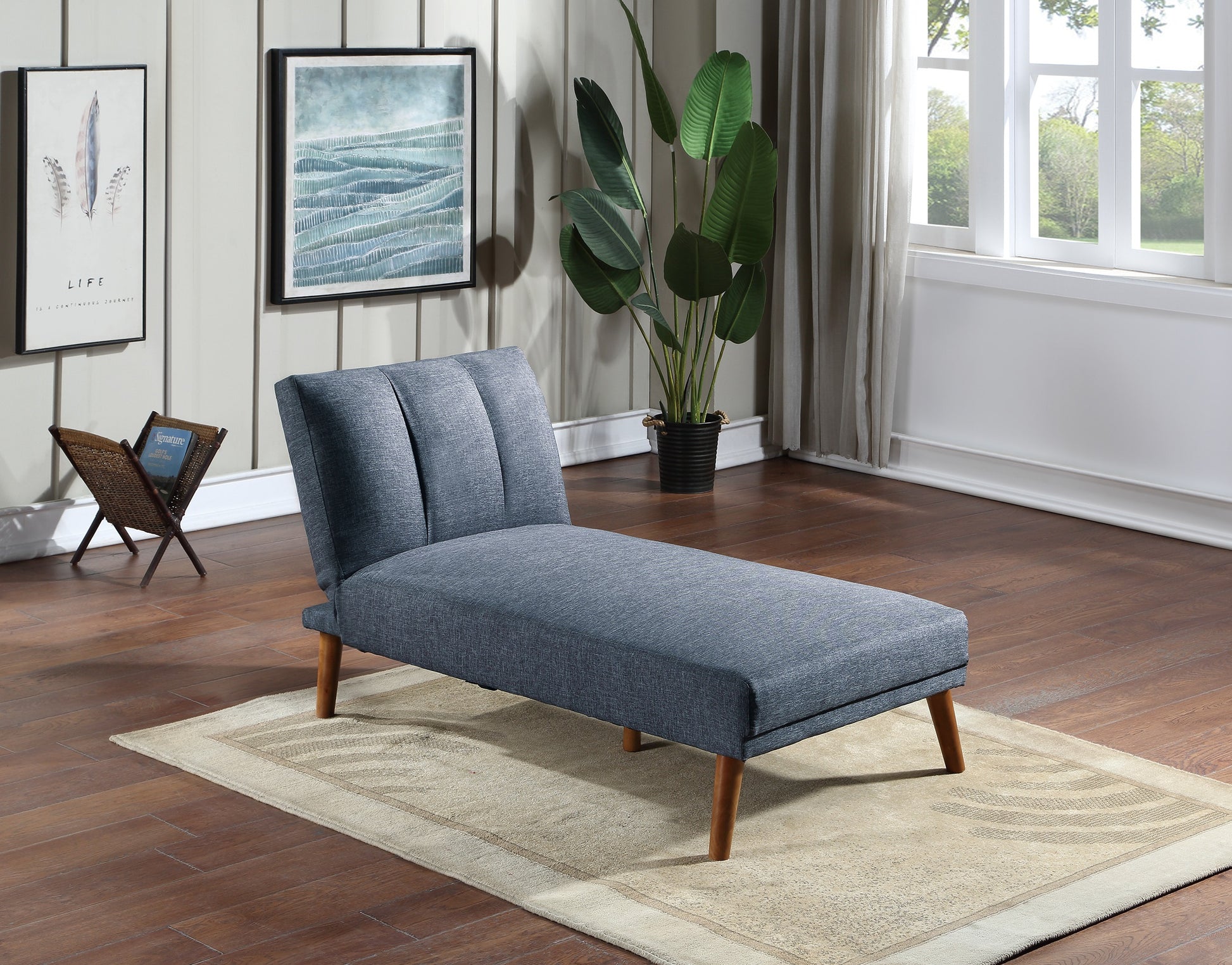Blue upholstered chaise lounge with tufted back and wooden legs