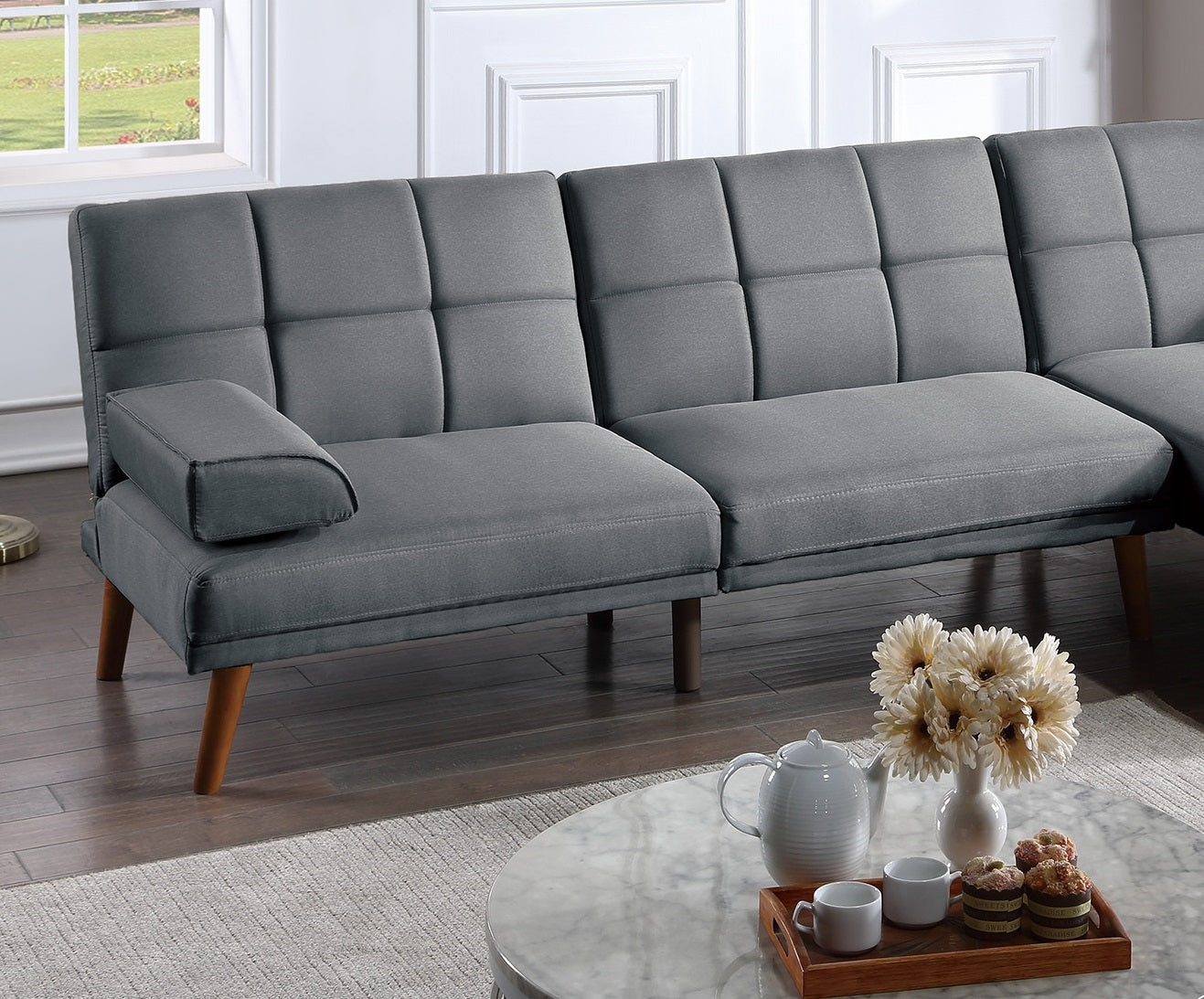 Modern grey fabric futon sofa with tufted cushions and wooden legs for small spaces