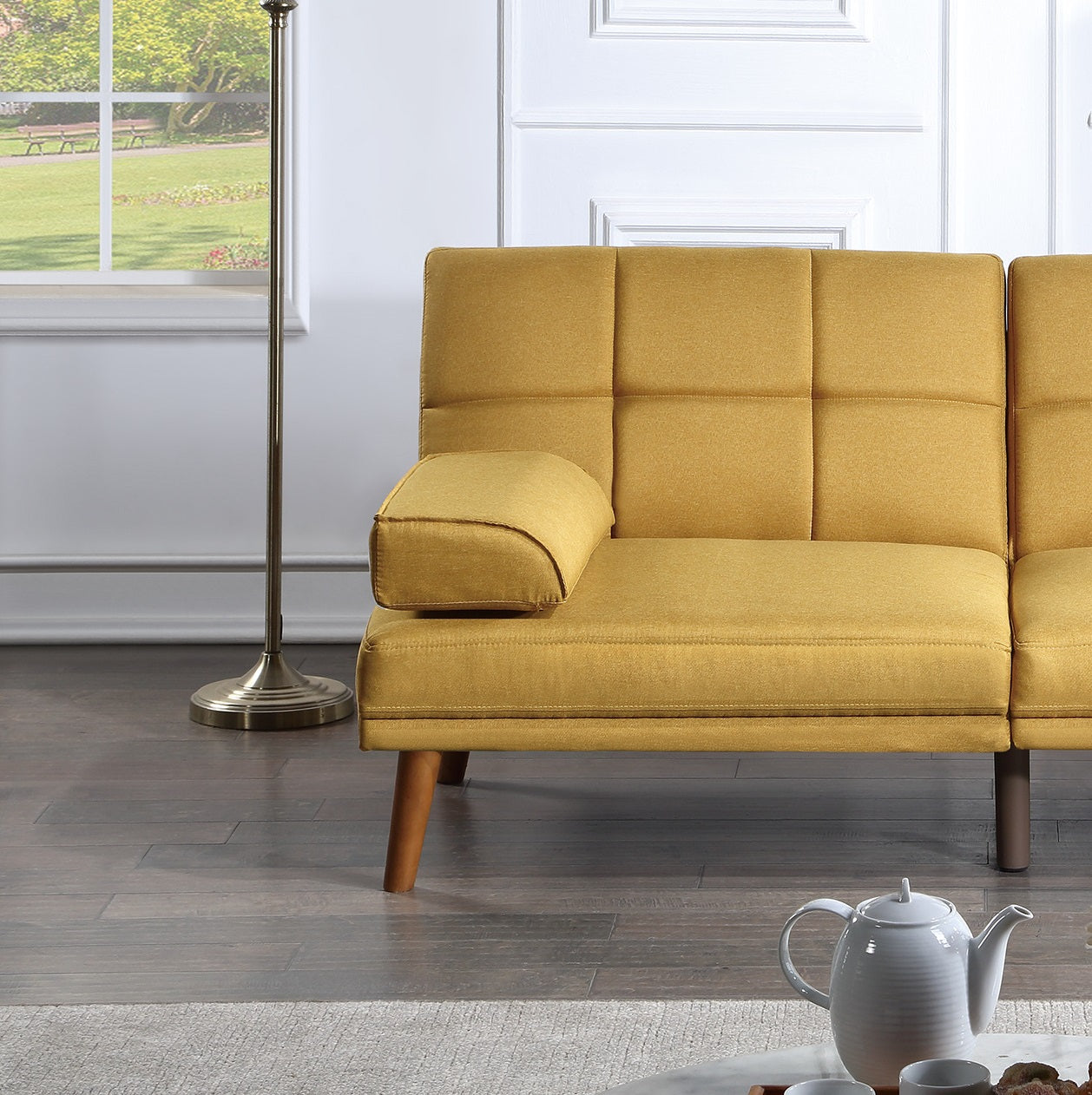 Gold mustard futon sofa with tufted back and wooden tapered legs